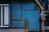 Aerial view of blue basketball and sports courts in school playground