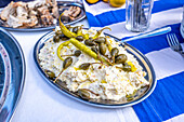 Close up of a traditional ensaladilla rusa garnished with peppers and capers, presented on a festive table during a wedding celebration in Malaga, Spain.