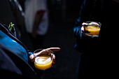 Close up of guests enjoying mimosa cocktails at a wedding party in Malaga, Spain. Celebratory atmosphere and stylish gathering in a beautiful location.