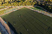 Aerial view of amateur soccer match at sunset