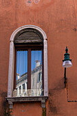 Chimneys reflected in a window in Venice, Italy.