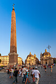 Rome, Italy, July 2017, Crowded Piazza del Popolo with historic obelisk and twin churches in Rome.