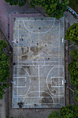 Basketball and soccer exterior courts among trees in city park, Zaragoza, Spain