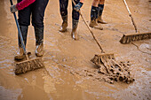 People cleaning. Effects of the DANA floods of October 29, 2024, Pelayo street, Paiporta, Comunidad de Valencia, Spain