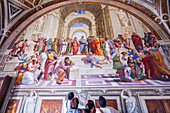 Rome, Italy, July 22 2017, A group of visitors marvels at Raphael's School of Athens in the Vatican Museums, exploring the masterpiece in Rome, Italy.