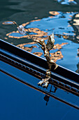 Detail of the traditional decoration of a gondola in Venice, Italy, showing a small, brass angel.