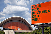 The House of World Cultures showcases its striking architecture against a cloudy sky in Berlin, inviting global cultural exchange.