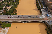 Aerial view of an abundant Ebro River passing under the Bridge after the Dana, Zaragoza, Spain