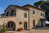 Traditional architecture of a farmhouse on a lavender farm in Sienna Province, Italy.