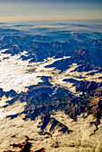 The breathtaking Pyrenees mountains rise above thick clouds, offering a stunning aerial perspective at dawn.