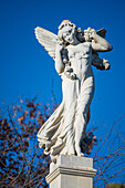 This image showcases a detailed angel statue in Plaza de America, located in the Maria Luisa Park, Seville. The serene expression and graceful pose embody tranquility and elegance.