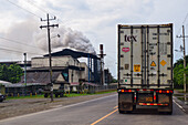 Smoke coming out of a factory chimney and truck on road, Costa Rica