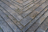 A chevron design in the flagstone paving in the medieval walled town of Monteriggioni, Sienna, Tuscany, Italy.