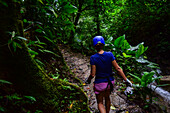 Young caucasian woman canyoning and rappelling in Costa Rica