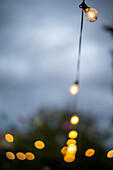 A warm ambiance created by glowing string lights at a wedding party in Malaga, Spain. The enchanting lighting sets a festive and romantic atmosphere for the evening celebration.