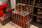 Cans of olive oil for sale in the shop of an olive oil mill in Italy.