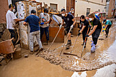 People cleaning. Effects of the DANA floods of October 29, 2024, Convent street, Paiporta, Comunidad de Valencia, Spain