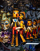 Pinocchio marionettes and carnival masks for sale in a souvenir shop in Venice, Italy.