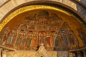 Mosaic art in a lunette on the facade of St. Mark's Basilica in Venice, Italy. This mosaic depicts the recovery of the relics of St. Mark from Egypt to Venice. Shown is the body of St. Mark being carried into the basilica.