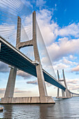 The impressive Vasco da Gama bridge stretches across the Tagus River, showcasing modern engineering and scenic views of Lisbon.