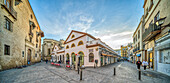 Seville, Spain, Jan 28 2021, Explore the picturesque Plaza de Calderon de la Barca in Sevilla, featuring the historic Mercado de Feria. Captured during sunset, this vibrant scene showcases local architecture and inviting pathways.