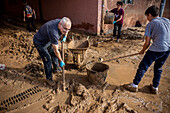 People cleaning. Effects of the DANA floods of October 29, 2024, in Benetusser street, Paiporta, Comunidad de Valencia, Spain