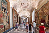 Rome, Italy, July 22 2017, Tourists admire intricate tapestries while visiting the Vatican Museums' stunning tapestry room in Rome.