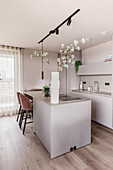 Kitchen island with flower arrangement made from cherry branches