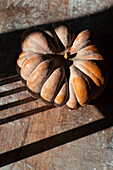 Pumpkin still life on wooden table in autumn light