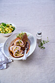 Pork roulade with apple and nut filling and herbs