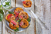 Baked apple rings with cinnamon sugar and redcurrants