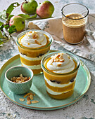Layered apple dessert with quark, sultanas and almonds