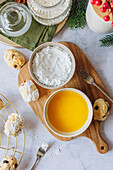 Prepare Quarkstollen confectionery with marzipan: liquid butter for spreading and icing sugar for dusting