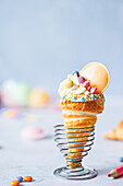 Puff pastry school cone with cream and sweets