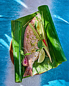 Sea bream with garlic, lemongrass and chilli in a banana leaf
