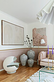 Living room with pastel pink accents, abstract art and floor vases