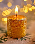 Golden, burning Christmas candle