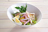 Rural salad with egg, ham and chicken breast