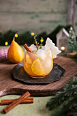 Winter pear gin and tonic with cinnamon, lemon and thyme