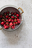 Fresh sour cherries in a sieve