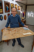 Pasquale Stinga showing the tiny pieces used to make intarsia or inlaid wood art in Sorrento, Italy.