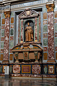 The tomb of Ferdinando I in the Chapel of the Princes in the Medici Chapel Museum in Florence, Italy. The sarcophagus is made of porphyry stone.