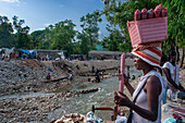 Garbage and street sellers on banks of Riviere de la Cosse, Jacmel, Haiti