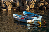 Two small rowboats moored in the harbor in Riomaggiore, Cinque Terre, Italy.