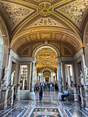 Tourists in the Gallery of the Candelabra, Pio Clementino Museum, Vatican Museums, Vatican City, Rome, Italy.