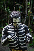 The Skeleton Men from the Omo Bugamo tribe of Papua New Guinea paint their bodies with black and white paint emulating the human skeleton, Chimbu Province, Papua New Guinea