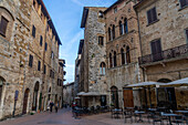 Der Palazzo Tortoli auf der Piazza della Cisterna in der ummauerten Stadt San Gimignano, Italien. Die Via del Castello verlässt die Piazza in östlicher Richtung.