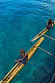 Residents of Tungelo Island in their traditional dugout canoes, New Ireland province, Papua New Guinea