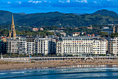 Landscape view over Playa de La Concha beach in San Sebastian, Gipuzkoa, Donostia San Sebastian city, north of Spain, Euskadi, Euskaerria, Spain. Hotel Londres (London) first building on right overlooking beach.