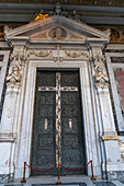 Bronze door of the main portal of the Basilica of St. Paul Outside the Walls, Rome, Italy.